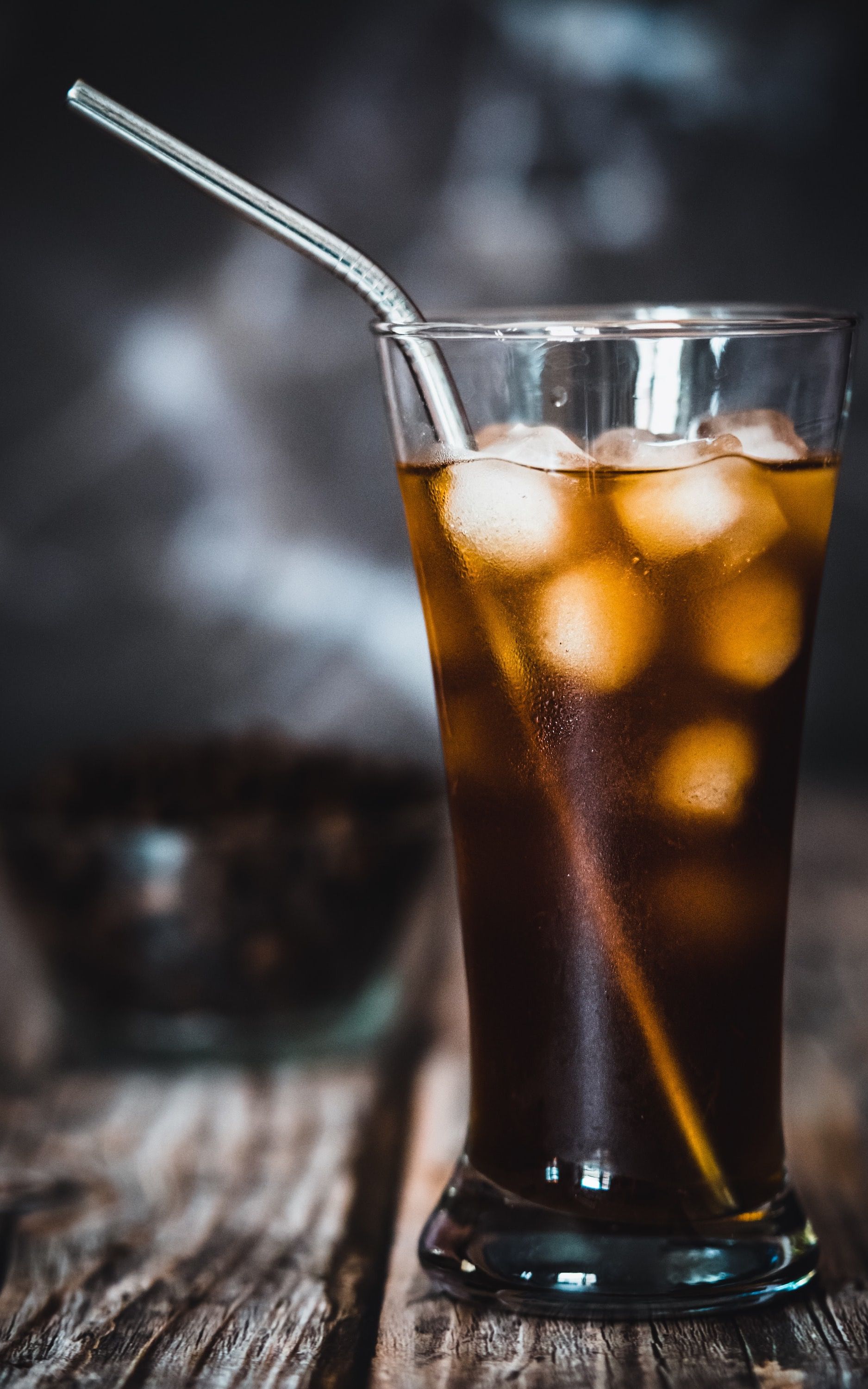 clear drinking glass with brown liquid